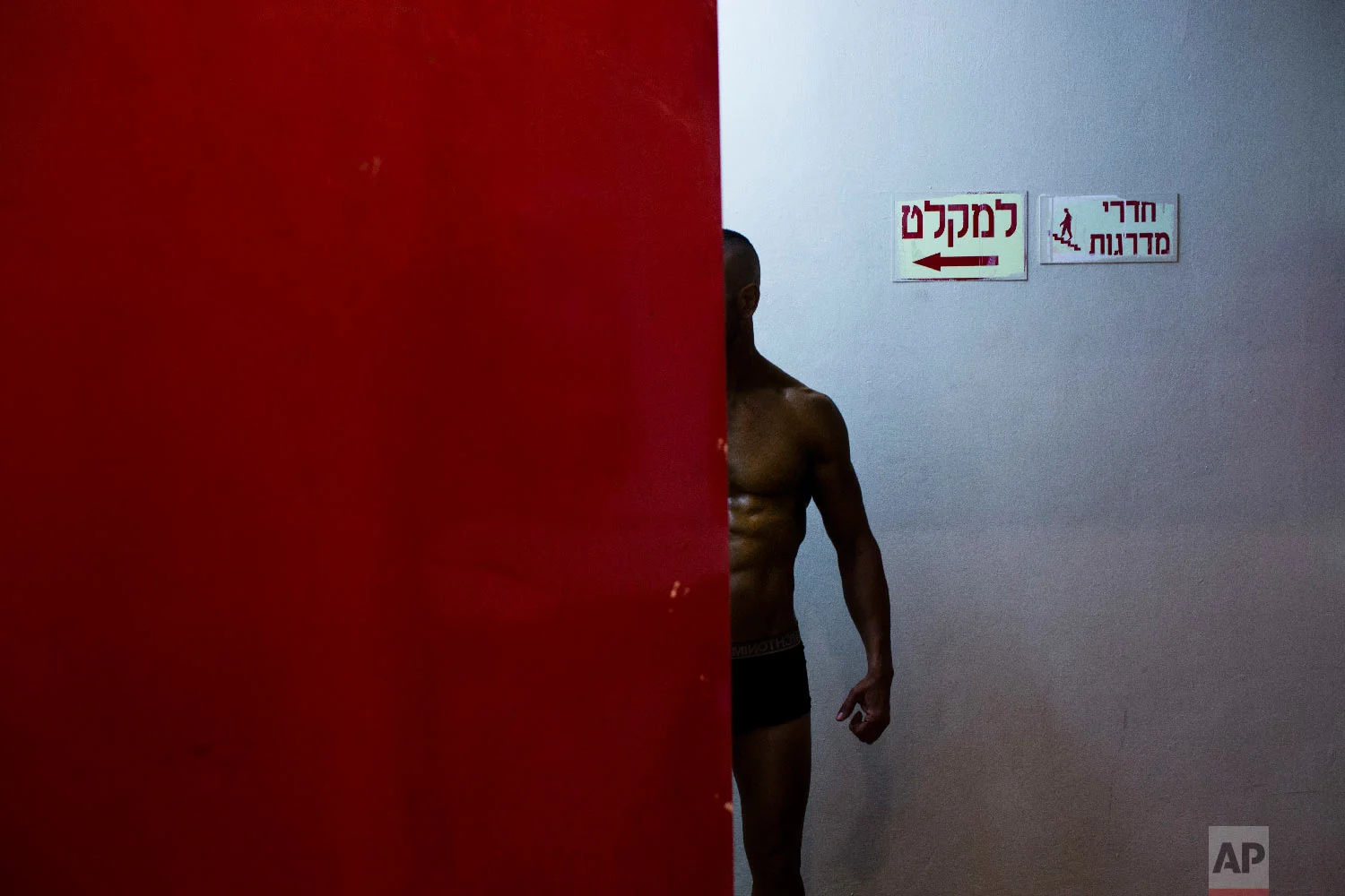 A contestant has his body painted backstage during the National Amateur Body Builders' Association competition in Tel Aviv, Israel, Oct. 18, 2018. (AP Photo/Oded Balilty)