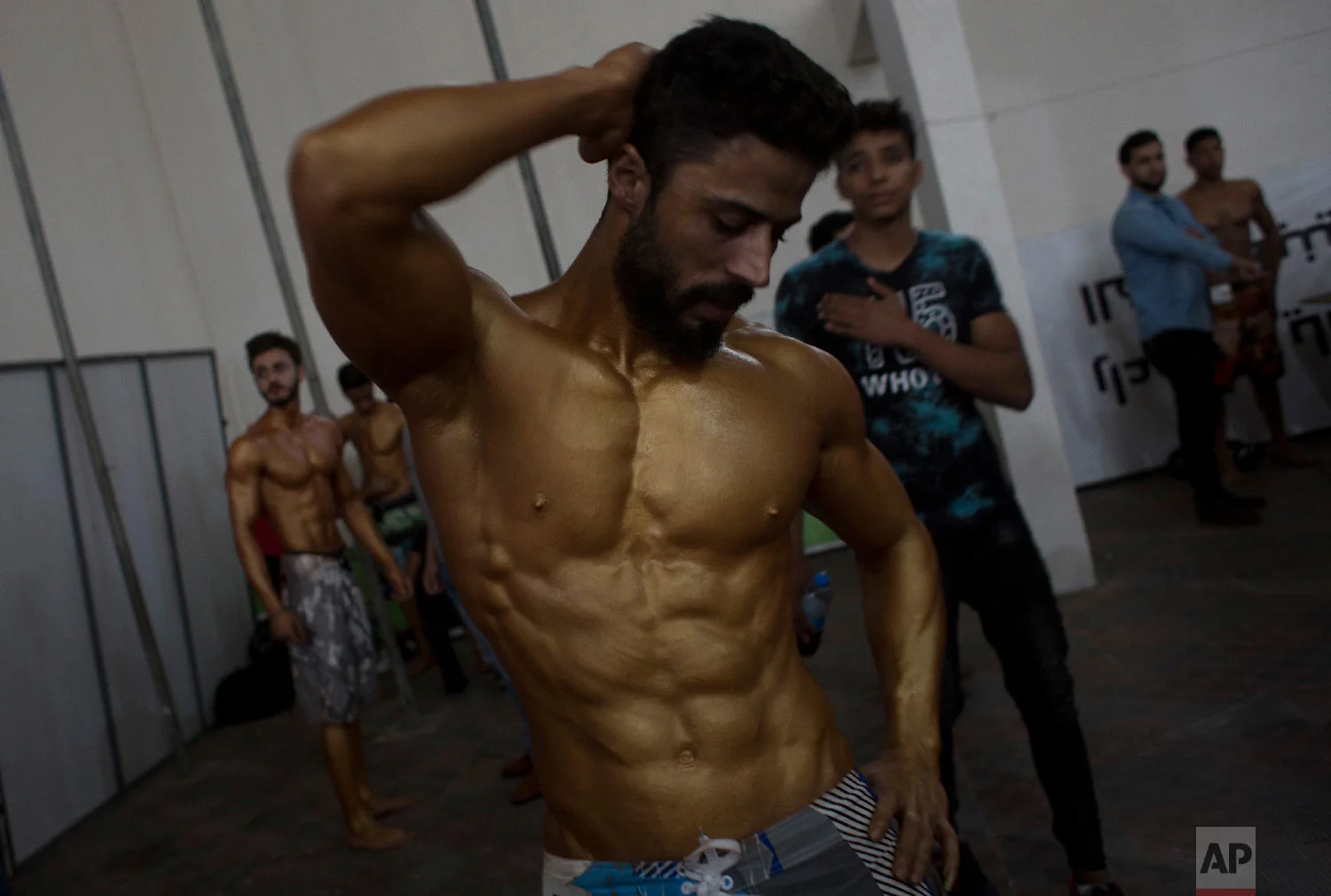 APalestinian bodybuilder prepares himself before giving a performance during a local bodybuilding competition, in Gaza City, Oct. 26, 2018. (AP Photo/Khalil Hamra)
