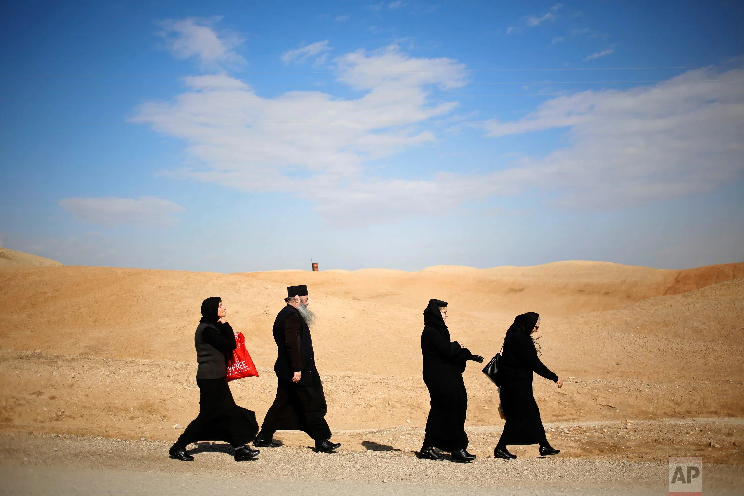 Christians walk to the traditional Epiphany baptism ceremony at the Qasr-el Yahud baptism site, in the Jordan river near the West Bank town of Jericho, Jan. 18, 2018. (AP Photo/Ariel Schalit)