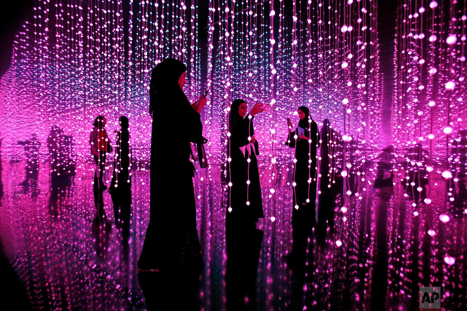 Emirati women takes a selfie at an exhibition called Edge of Government at the Museum of the Future of the World Government Summit in Dubai, United Arab Emirates, Feb. 12, 2018. (AP Photo/Kamran Jebreili)