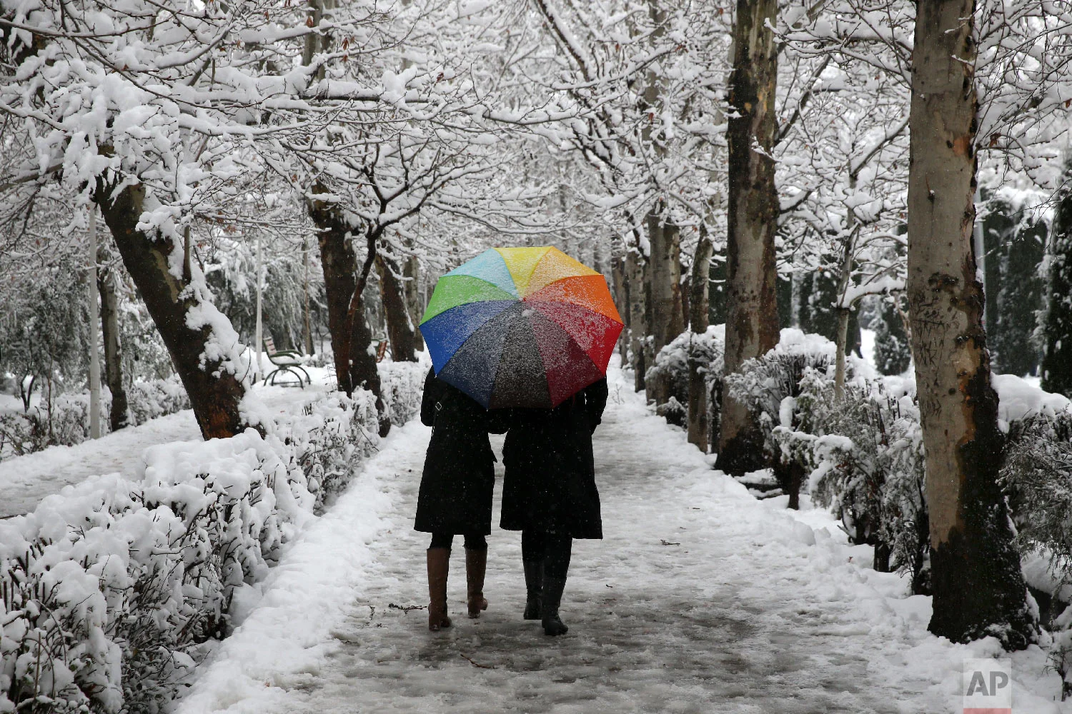 Two Iranians walk in Laleh Park in central Tehran, Iran, Jan. 28, 2018. (AP Photo/Vahid Salemi)