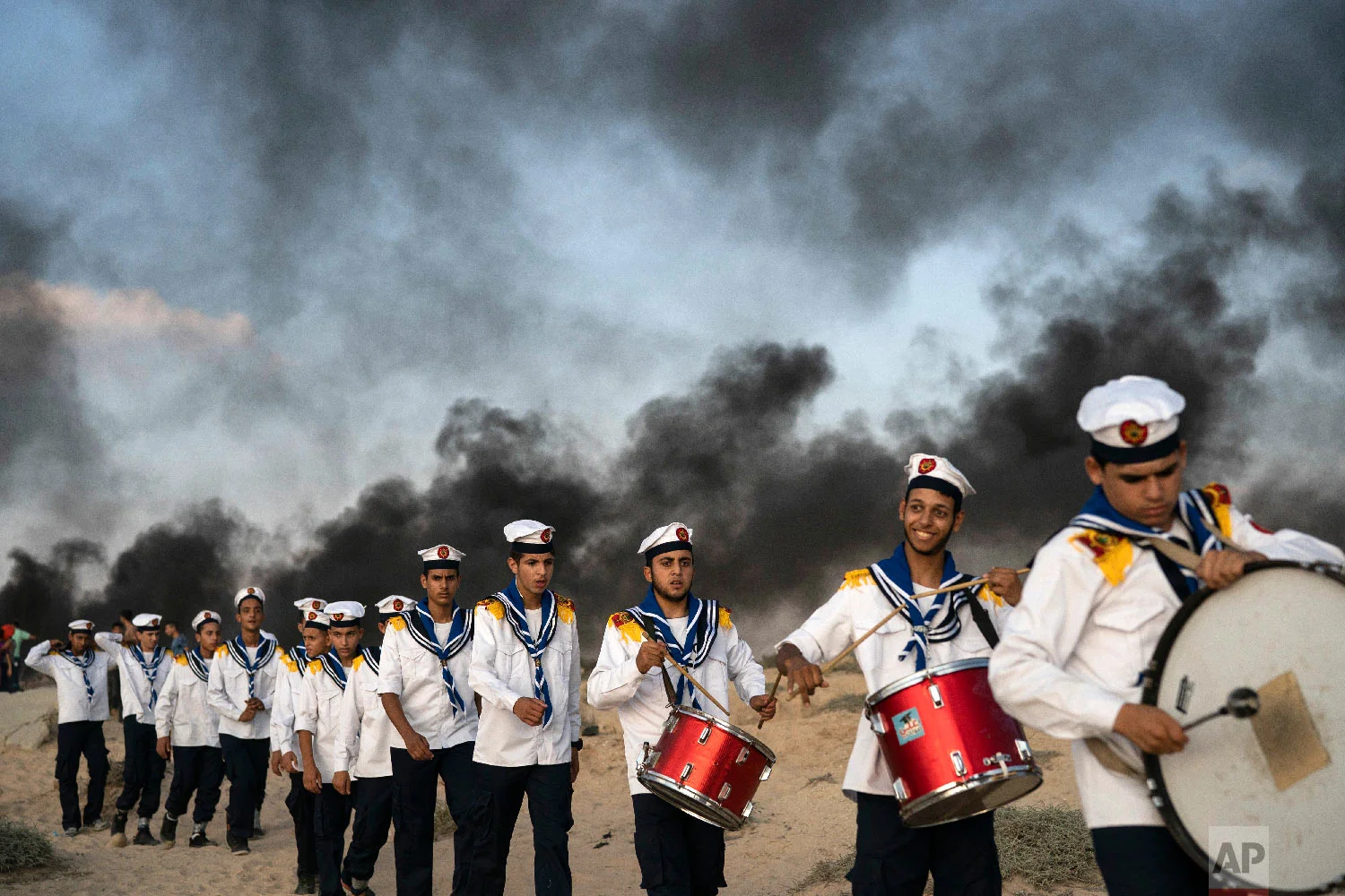Palestinian boy scouts march during a protest on the beach near the border with Israel in Beit Lahiya, northern Gaza Strip, Sept. 10, 2018. (AP Photo/Felipe Dana)