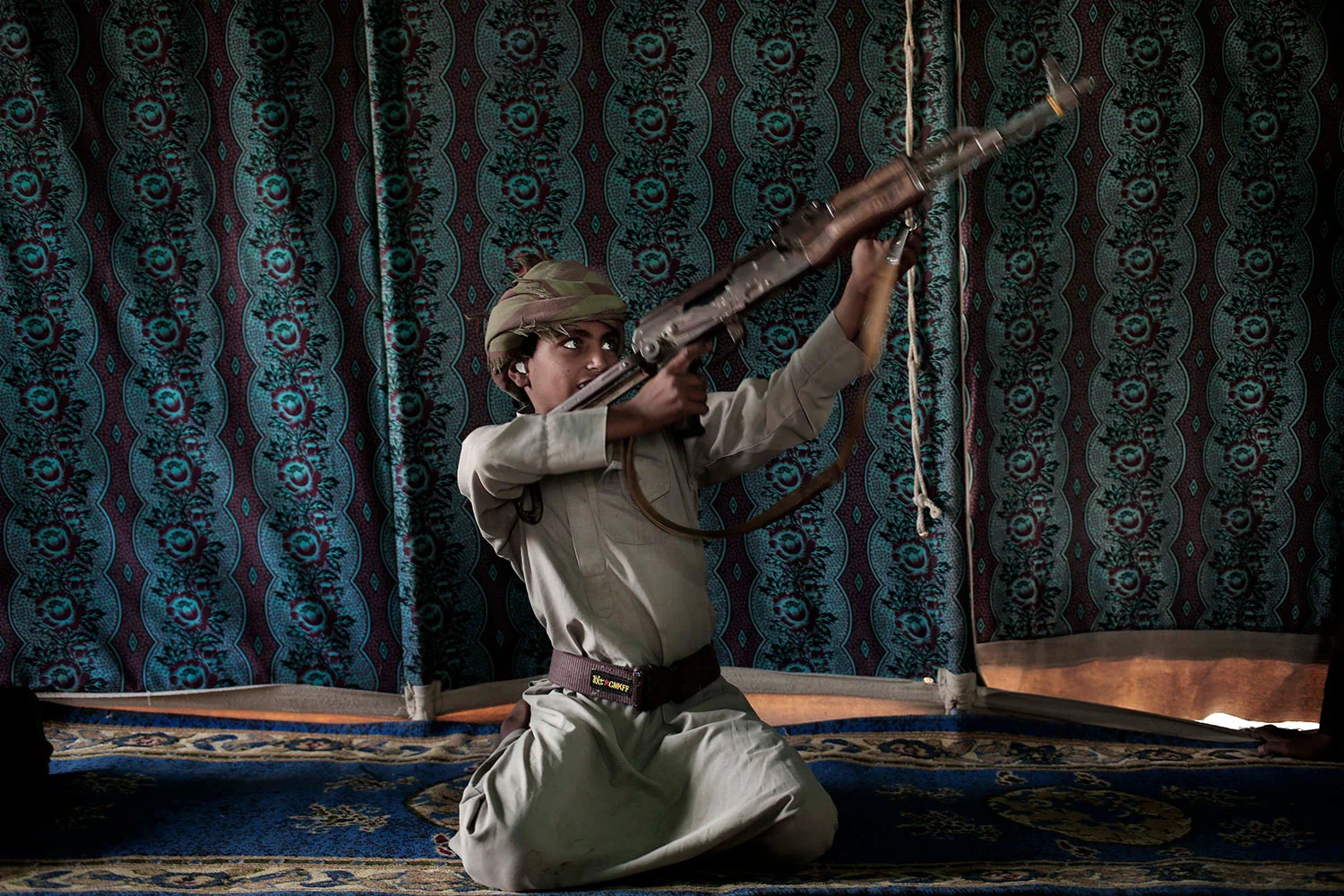 Kahlan, a 12-year-old former child soldier, demonstrates how to use a weapon, at a camp for displaced persons where he took shelter with his family, in Marib, Yemen in this July 27, 2018 photo. (AP Photo/Nariman El-Mofty)