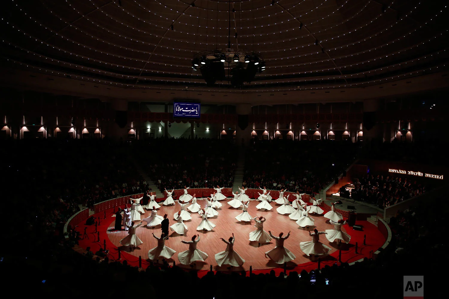 Whirling dervishes of the Mevlevi order perform at the start of a Sheb-i Arus ceremony in Konya, central Turkey, Sunday, Dec. 16, 2018. (AP Photo/Lefteris Pitarakis)