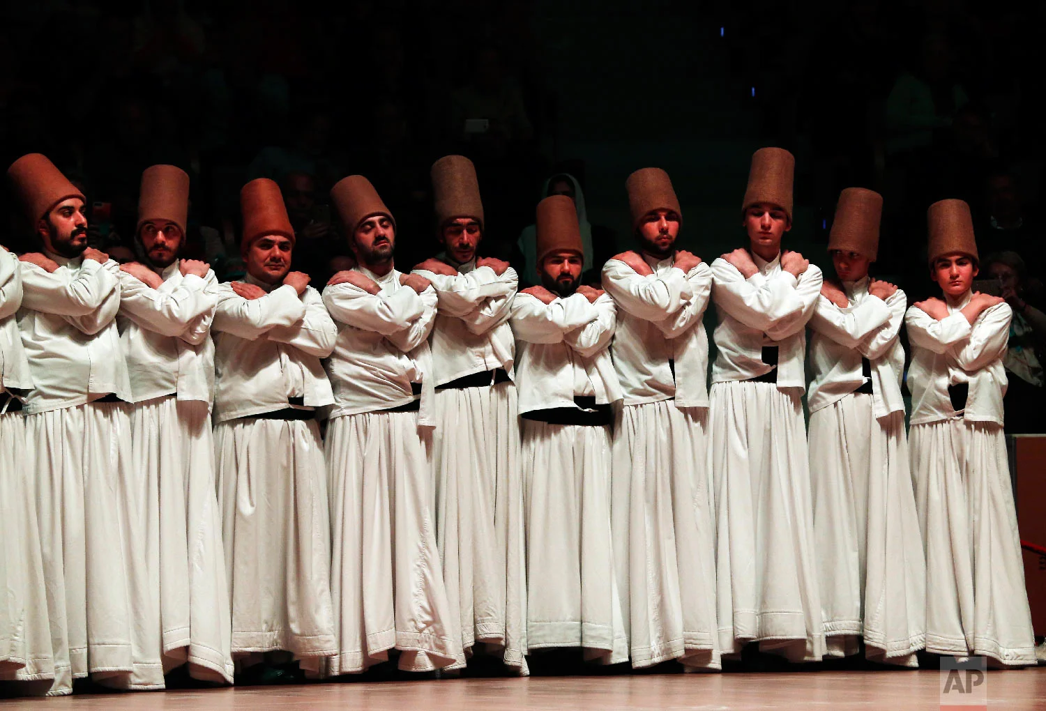 Whirling dervishes of the Mevlevi order prepare for the Sheb-i Arus ceremony in Konya, central Turkey, Sunday, Dec. 16, 2018. (AP Photo/Lefteris Pitarakis)