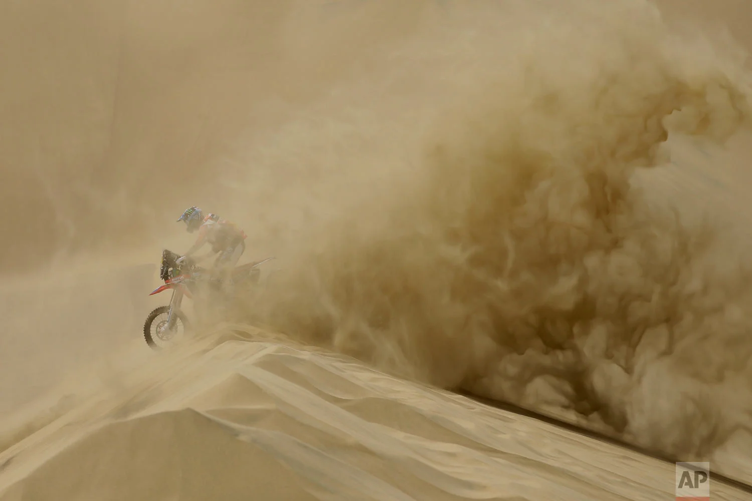In this Jan. 6, 2018 photo, U.S. athlete Ricky Brabec races his Honda motorbike during the Dakar Rally between Lima and Pisco, Peru. This year’s grueling Dakar Rally began on Peruvian sand dunes, took to the highlands of Bolivia and finished in Argentina. (AP Photo/Ricardo Mazalan)