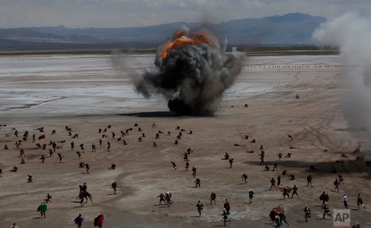 In this March 28, 2018 photo, Bolivian soldiers re-enact the battle of "Canchas Blancas," which took place during the Pacific War in 1879 when Bolivia lost to Chile, and in effect lost its access to the sea, in Canchas Blancas, Bolivia, the sight of the actual battle. Bolivia lost its legal battle this year at The Hague's International Court of Justice to recuperate the Pacific coastal lands from Chile. (AP Photo/Juan Karita)