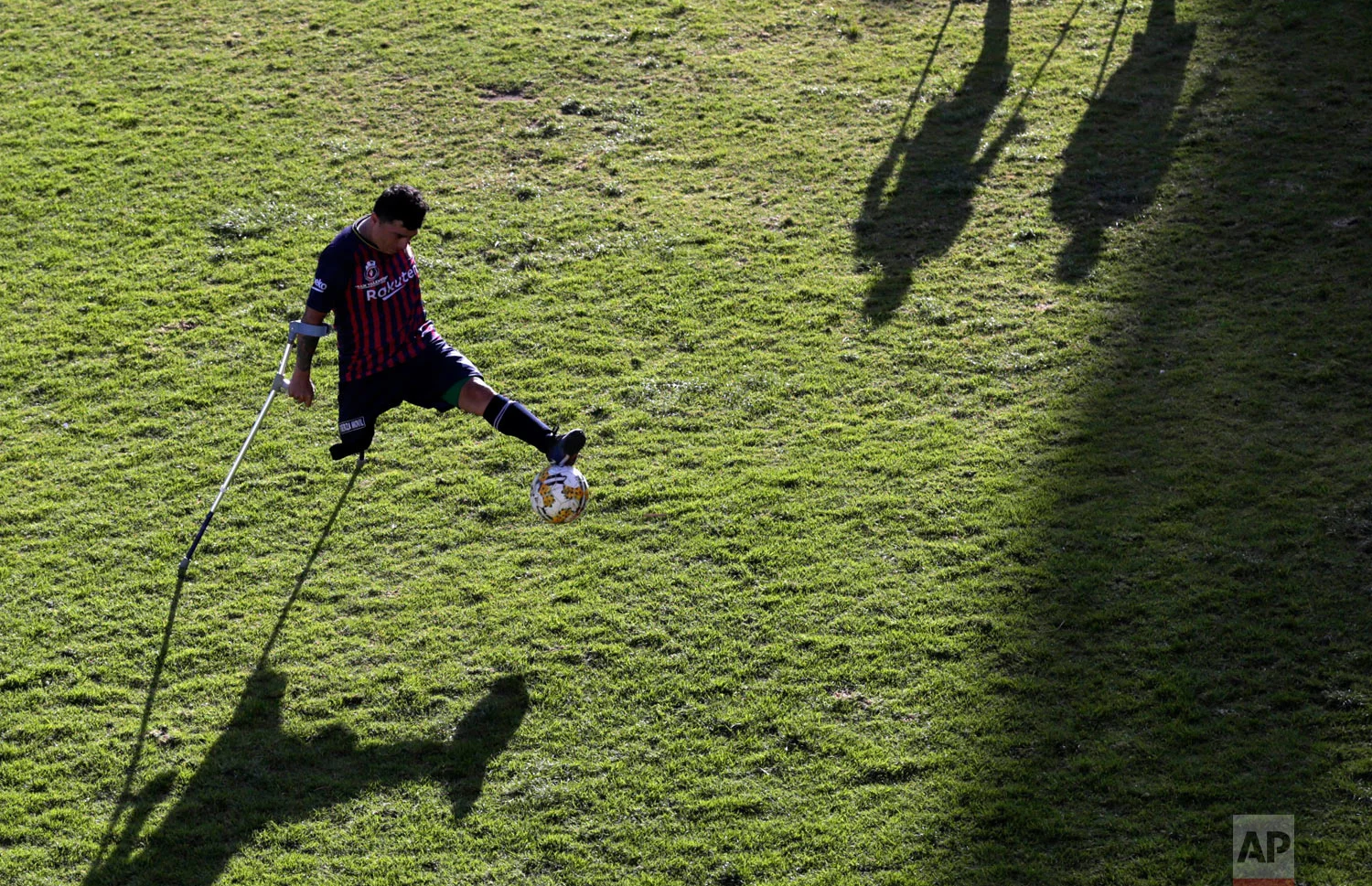 In this June 9, 2018 photo, Robin Burbano controls the ball on crutches during a game against El Empalme at a national soccer tournament for players with amputated limbs in Quito, Ecuador. (AP Photo/Dolores Ochoa)