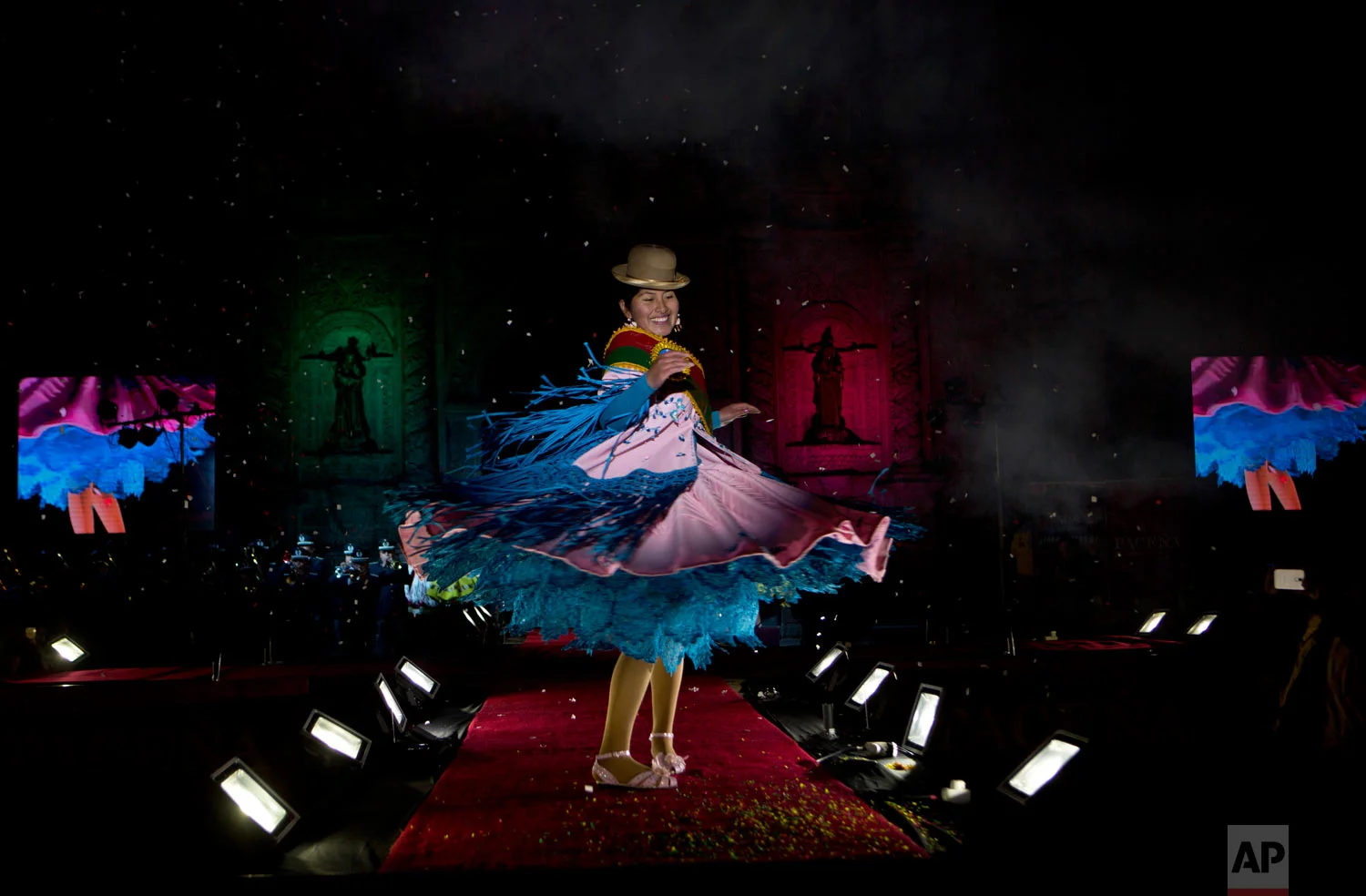In this June 29, 2018 photo, a woman turns on the catwalk during the Miss Cholita beauty pageant in La Paz, Bolivia. Aymara women participated in the contest that recognizes indigenous women's fashion and beauty as well as their command of indigenous lifestyle and language. (AP Photo/Juan Karita)
