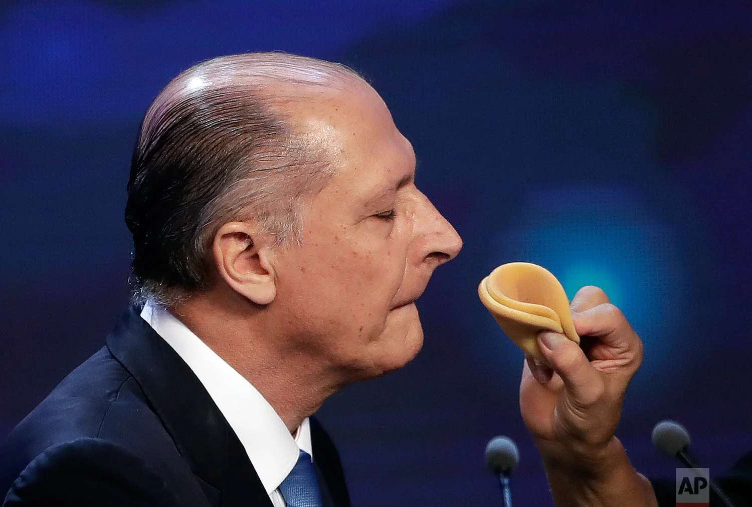 In this Aug. 10, 2018 photo, Geraldo Alckmin, a former governor and presidential hopeful, gets his make up done during a break at a presidential debate in Sao Paulo, Brazil. Alckmin lost to Congressman Jair Bolsonaro, who had almost double the support. (AP Photo/Andre Penner)