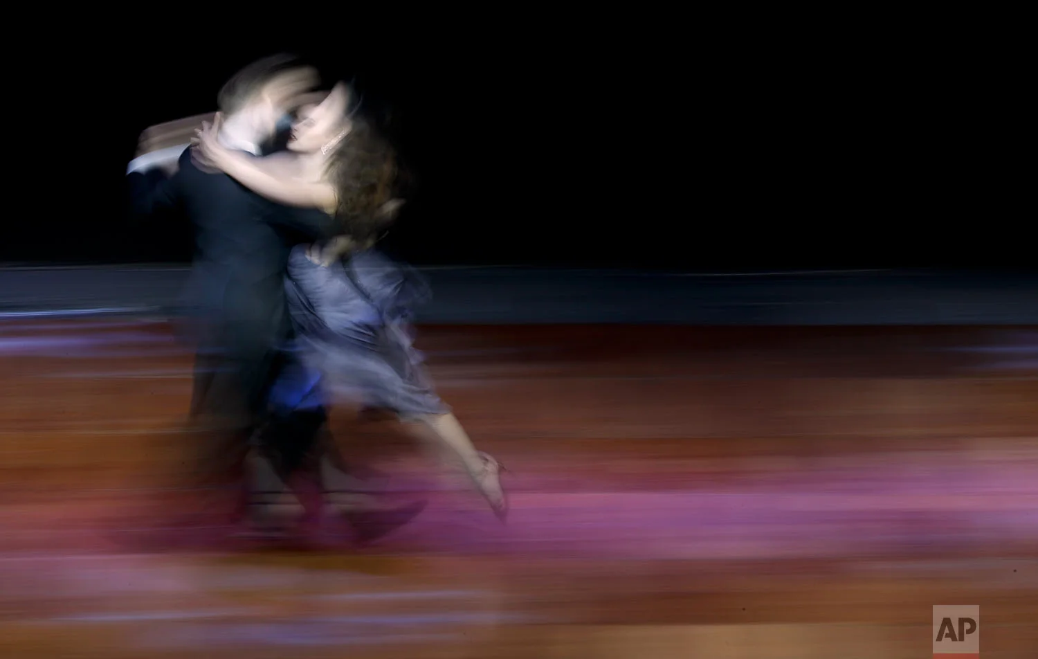 In this Aug. 22, 2018 photo, Argentine couple Maksim Gerasimov and Agustina Piaggio compete in the stage category of the World Tango Championship in Buenos Aires, Argentina. (AP Photo/Natacha Pisarenko)