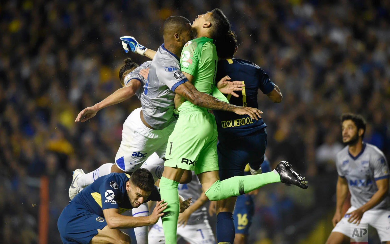 In this Sept. 19, 2018 photo, Dede of Brazil's Cruzeiro, left, and goalkeeper Esteban Andrada, of Argentina's Boca Juniors, collide during a Copa Libertadores soccer match in Buenos Aires, Argentina. (AP Photo/Gustavo Garello)