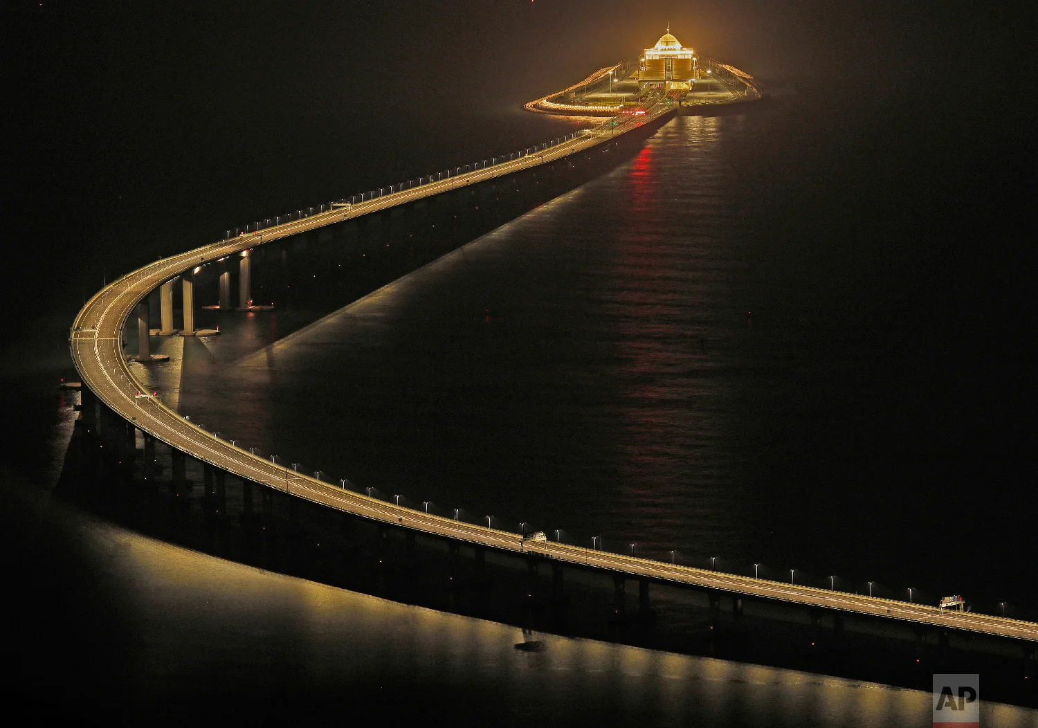 Hong Kong-Zhuhai-Macau Bridge, a total length of 55 kilometers (34 miles), is lit up in Hong Kong on Oct. 21, 2018. (AP Photo/Vincent Yu)