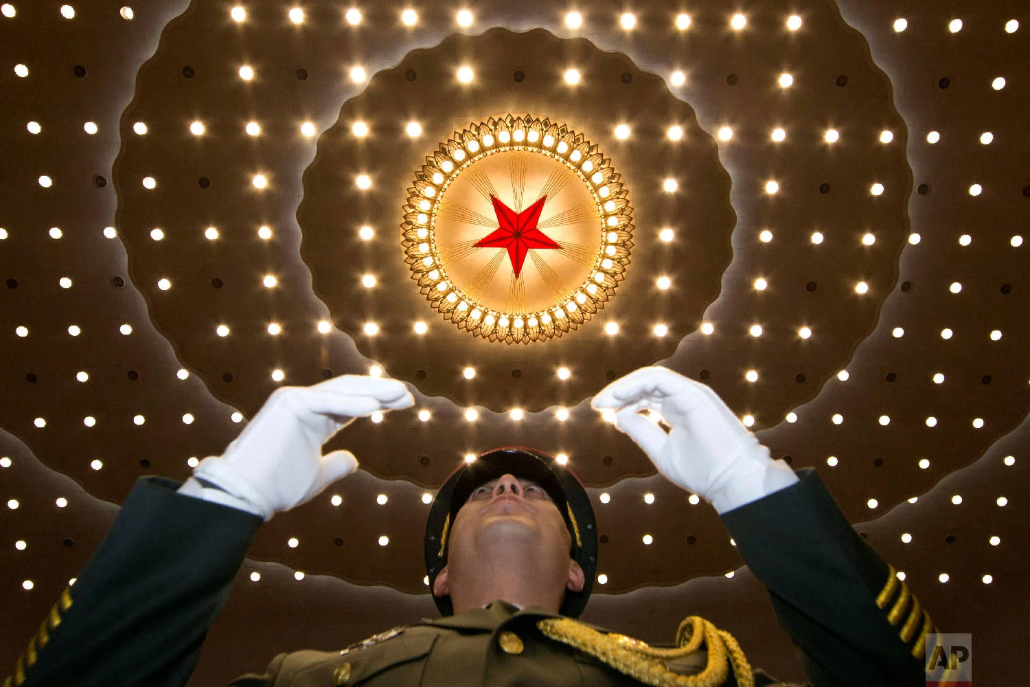 A military band conductor leads the band at the opening session of the Chinese People's Political Consultative Conference in Beijing's Great Hall of the People on March 3, 2018. (AP Photo/Ng Han Guan)