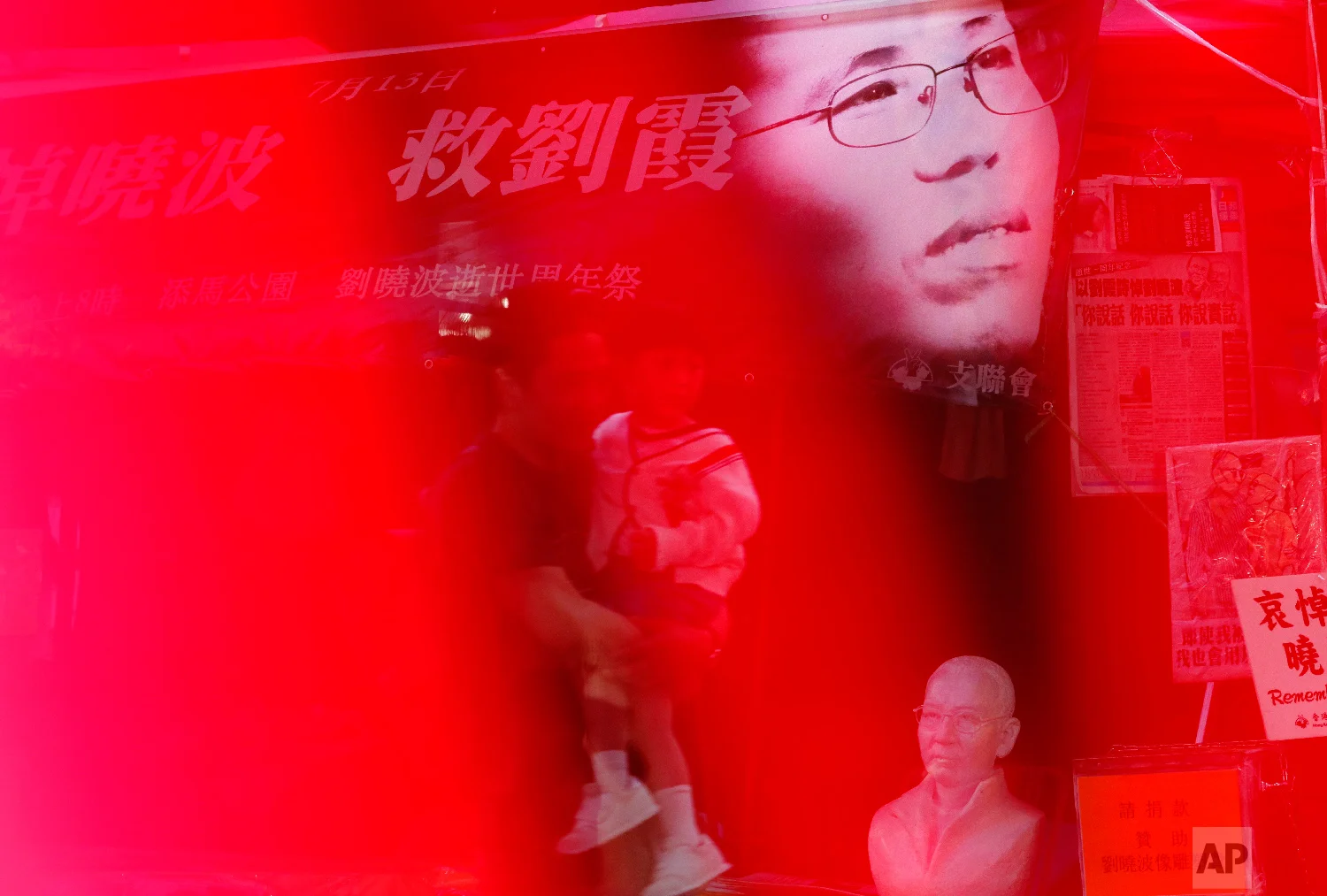 An image of Liu Xia, wife of the late Nobel Peace Laureate Liu Xiaobo, is displayed at a booth to collect signatures from the public in releasing of her at a down town street in Hong Kong on July 10, 2018. (AP Photo/Vincent Yu)
