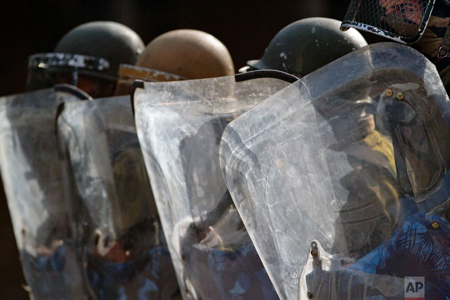 Policemen use their shields during clashes with Kashmiri protesters in Srinagar, India, on Oct. 24, 2018. (AP Photo/Dar Yasin)