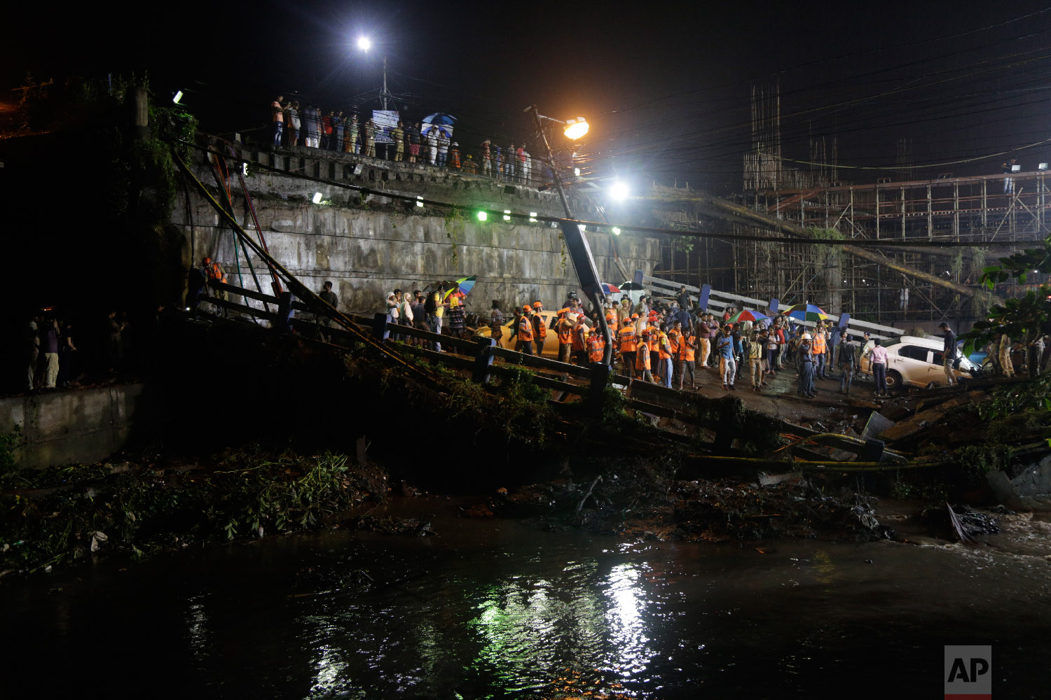  Rescuers work at the scene after a highway overpass collapsed on a sewage canal in Kolkata, India, on Sept. 4, 2018. (AP Photo/Bikas Das) 