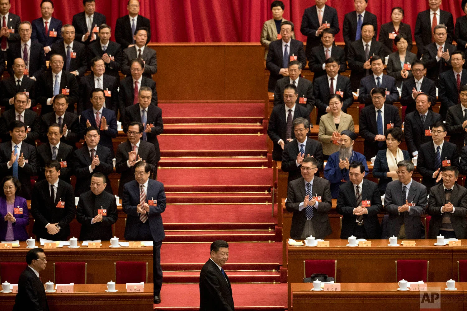 Chinese President Xi Jinping, center, arrives with Premier Li Keqiang, left, for the opening session of the Chinese People's Political Consultative Conference in Beijing's Great Hall of the People on March 3, 2018. (AP Photo/Ng Han Guan)