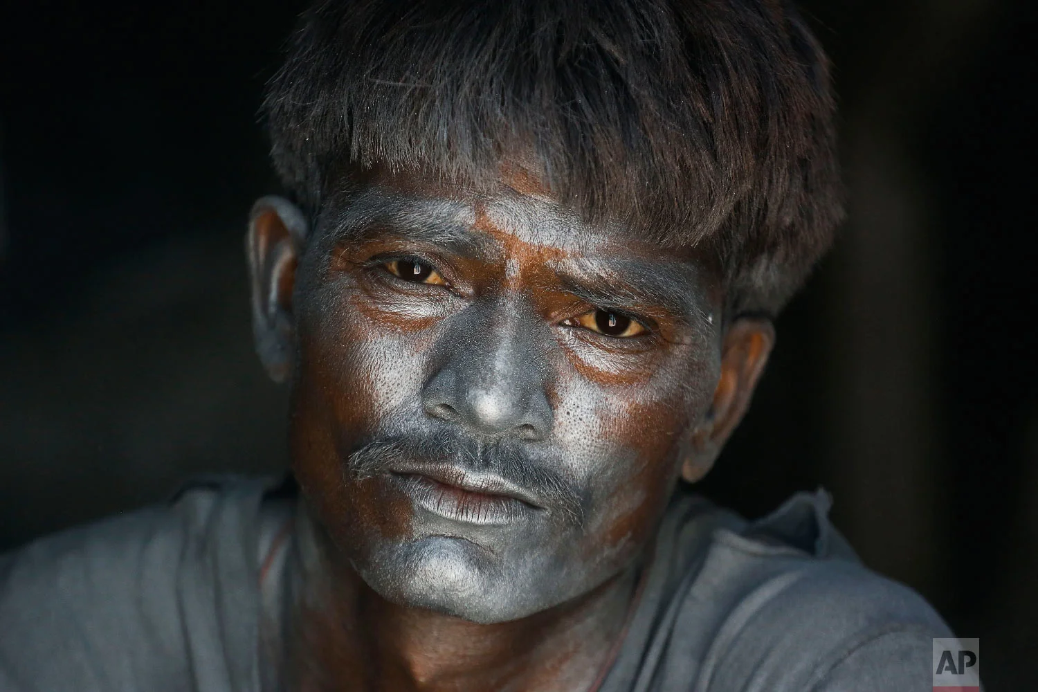 An Indian worker has gun powder on his face as he mixes the same to make fire-crackers for the upcoming Hindu festival Diwali at a factory on the outskirts of Ahmadabad, India on Oct. 22, 2018. Fire crackers will be in huge demand in India during Diwali, the festival of lights. (AP Photo/Ajit Solanki)