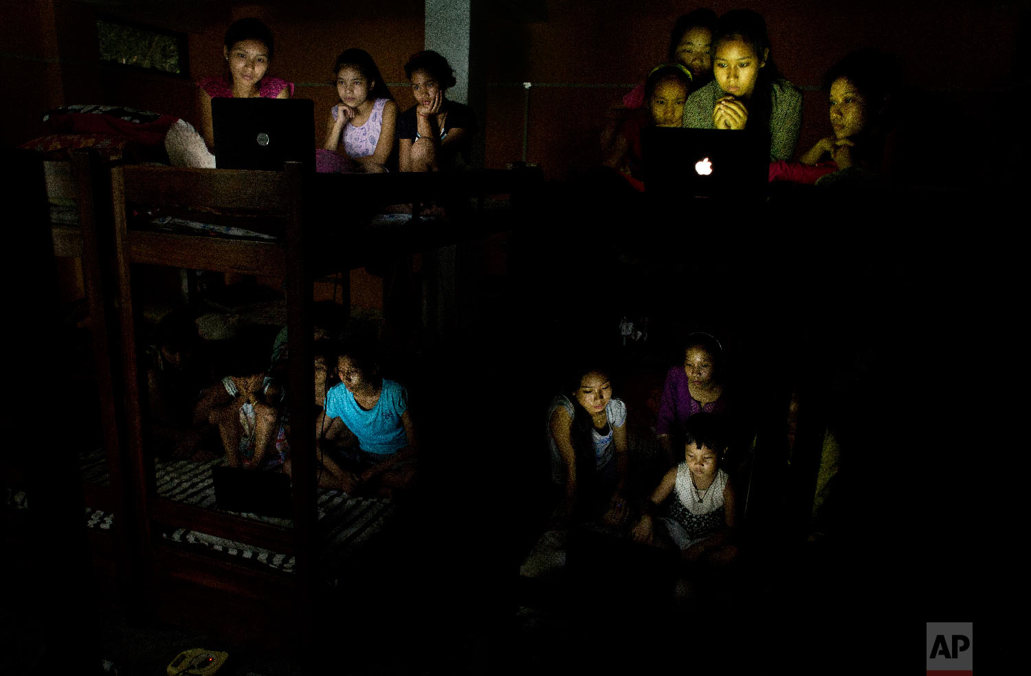  School children watch the World Cup soccer final match between France and Croatia on laptops at a hostel on the outskirts of Gauhati, India, Sunday, July 15, 2018, (AP Photo/Anupam Nath) 