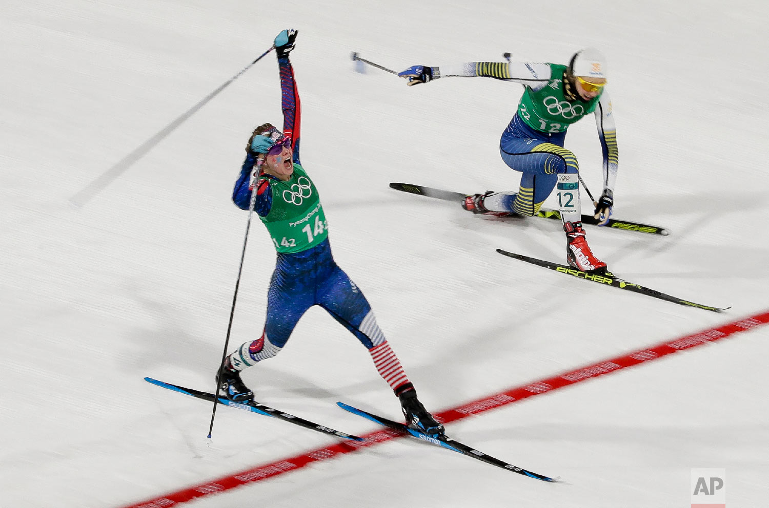  Jessica Diggins, left, of the United States, celebrates after winning the gold medal past Stina Nilsson, of Sweden, in the during women's team sprint freestyle cross-country skiing final at the 2018 Winter Olympics in Pyeongchang, South Korea, Wedne