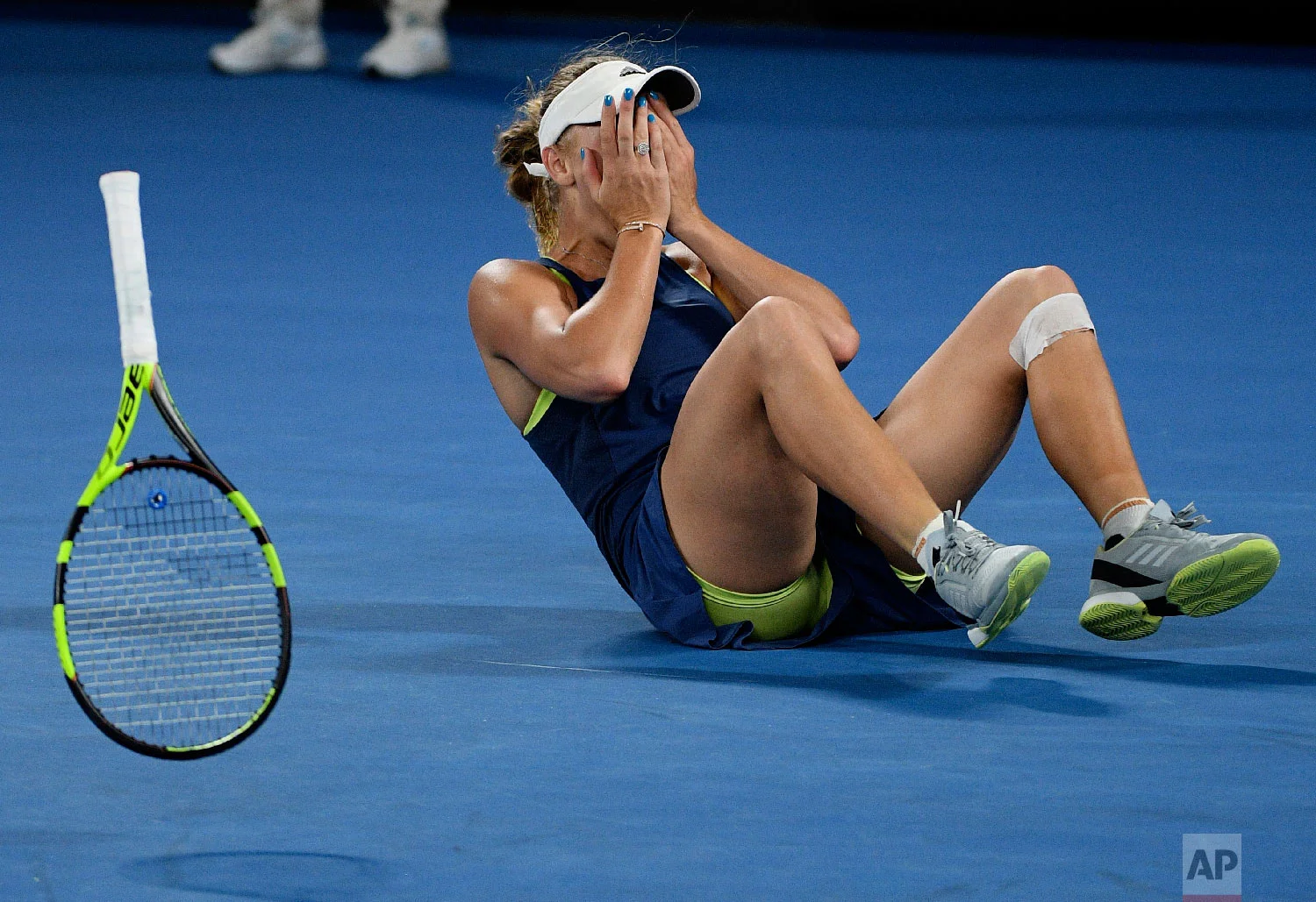 Denmark's Caroline Wozniacki celebrates after defeating Romania's Simona Halep during the women's singles final at the Australian Open tennis championships in Melbourne, Australia, Saturday, Jan. 27, 2018. (AP Photo/Andy Brownbill)