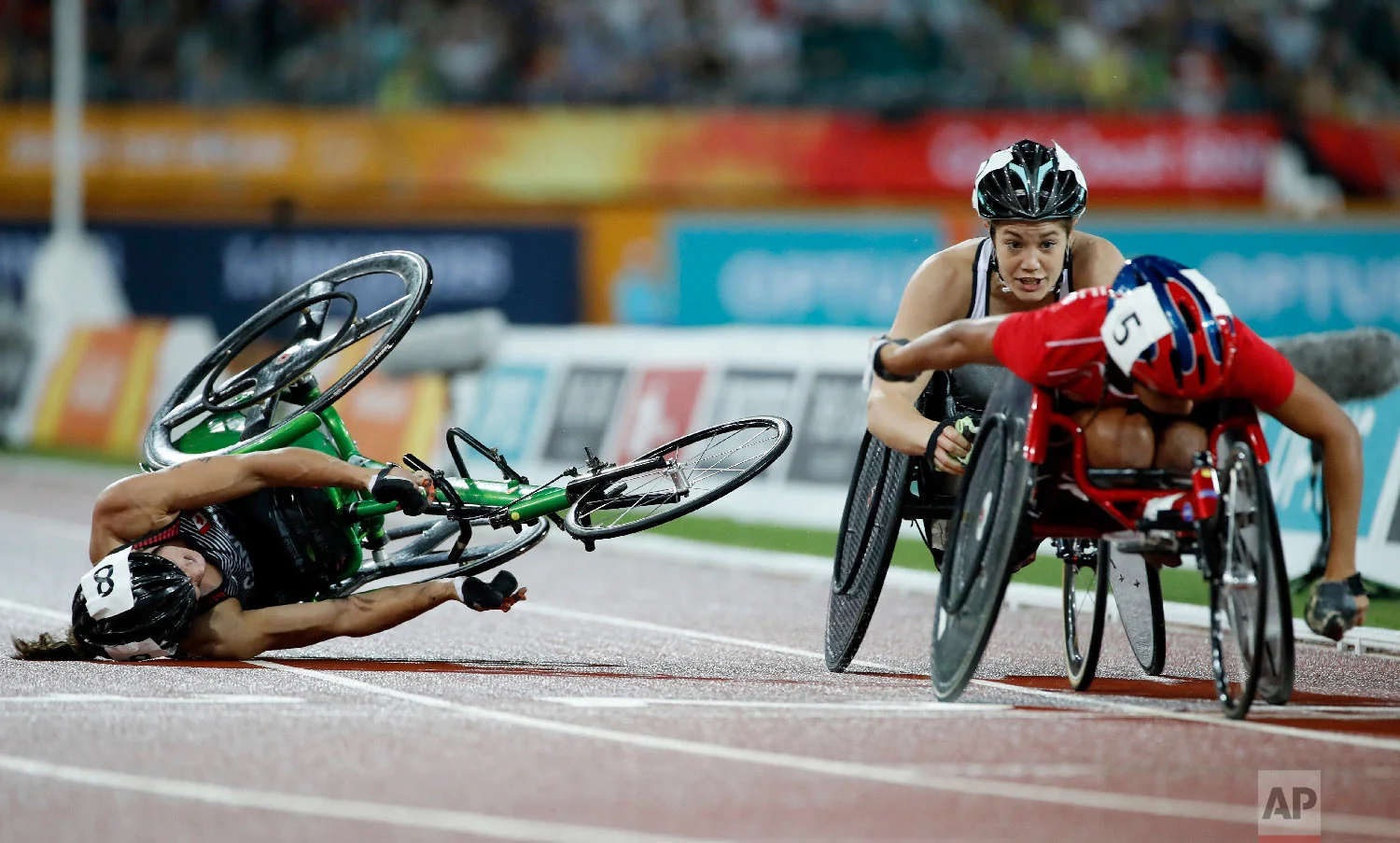 Canada's Jessica Frotten crashes during the women's T54 1500m final at Carrara Stadium during the 2018 Commonwealth Games on the Gold Coast, Australia, Tuesday, April 10, 2018. (AP Photo/Mark Schiefelbein)