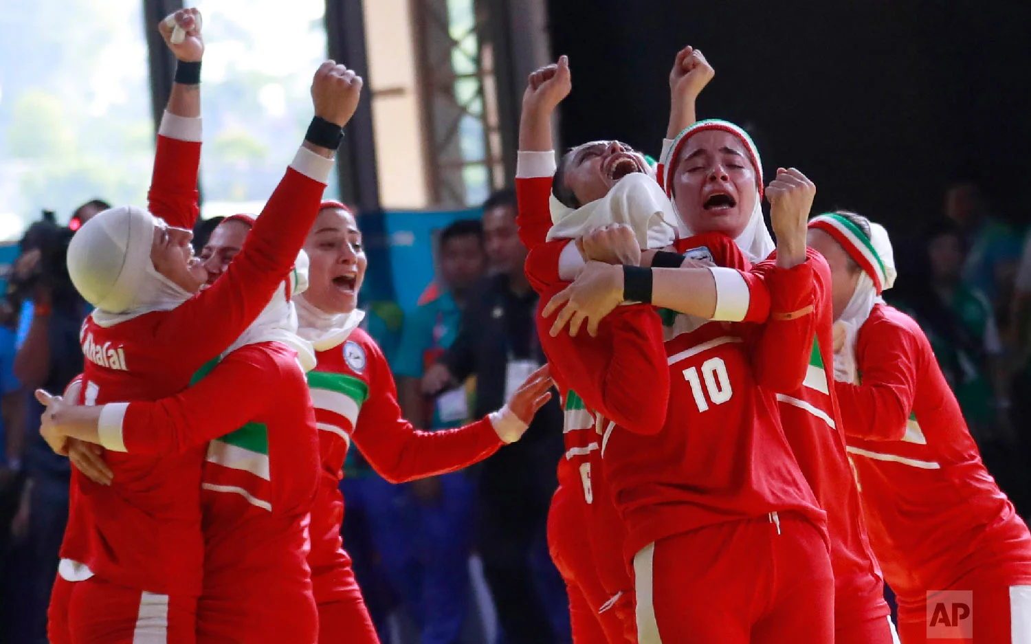 Iran's team, in red, react after defeating India's during at the women's team Kabaddi gold medal match at the 18th Asian Games in Jakarta, Indonesia, Friday, Aug. 24, 2018. Iran won gold.(AP Photo/Tatan Syuflana)