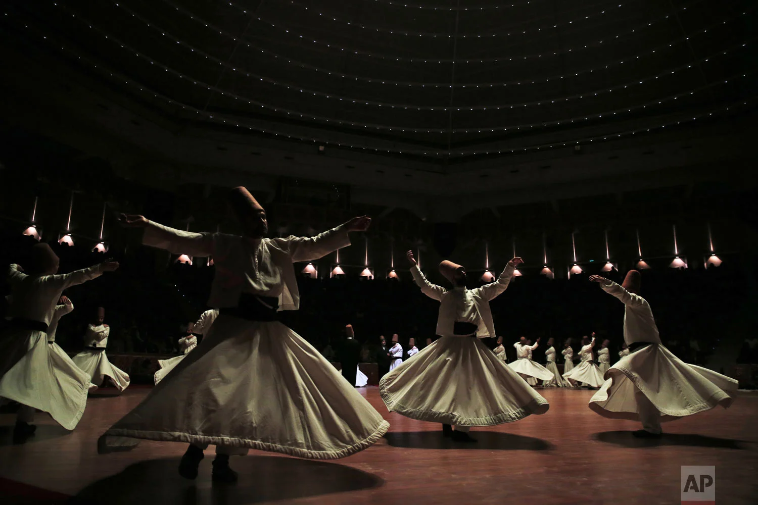 Whirling dervishes of the Mevlevi order perform during a Sheb-i Arus ceremony in Konya, central Turkey on Sunday, Dec. 16, 2018. Every December the Anatolian city hosts a series of events to commemorate the death of 13th century Islamic scholar, poet and Sufi mystic Jalaladdin Rumi. (AP Photo/Lefteris Pitarakis)