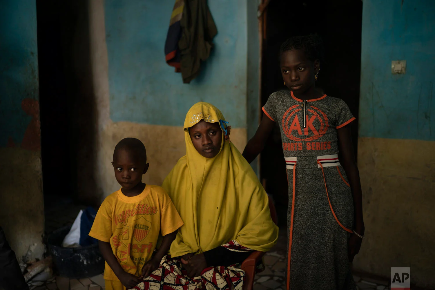 Mariama Konte, 20, sits with her daughter Maimouna, 7, and her son Ibrahima, 4, inside their home on Nov. 24, 2018, in a village near Goudiry, Senegal. Konte, who married Abdrahamane when she was 12 and he was 21, is living the consequences of the family’s decision in November to mourn him after nearly four years of waiting. (AP Photo/Felipe Dana)