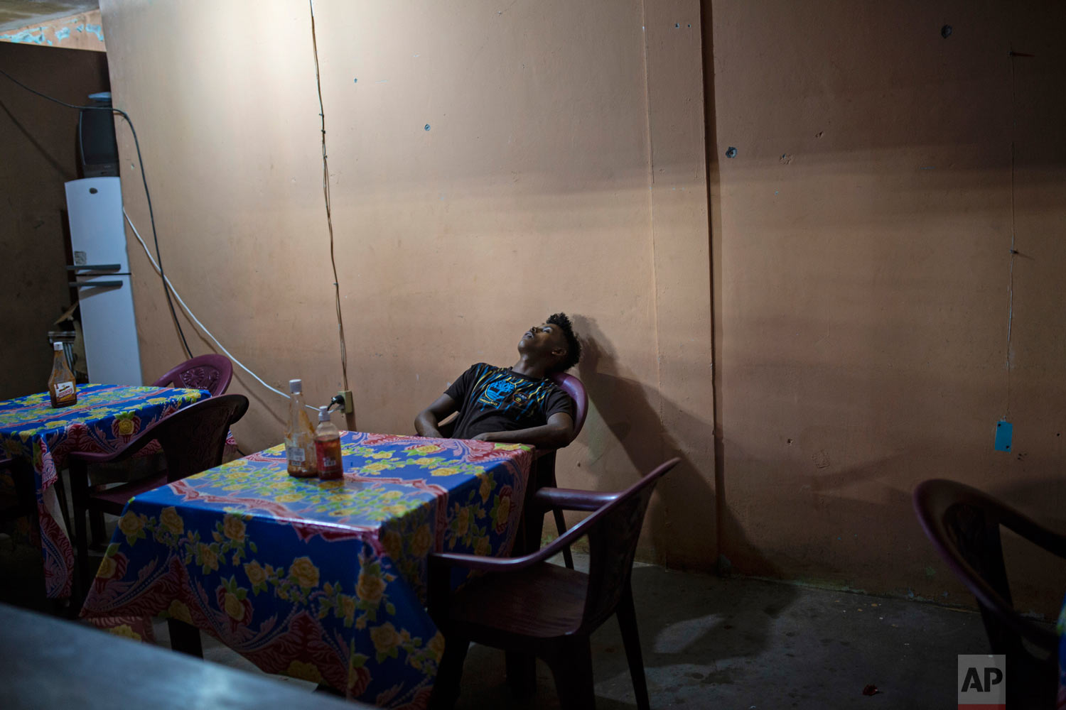  In this Feb. 9, 2018 photo, a man takes a nap inside a makeshift restaurant in Puerto Lempira, Honduras. (AP Photo/Rodrigo Abd) 