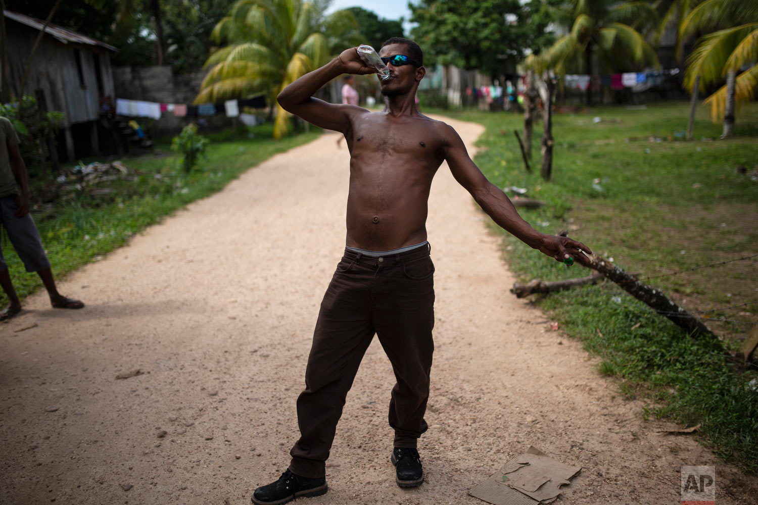  In this Feb 1, 2018 photo, Angel Ponce takes a swig of rum, in Puerto Lempira, Honduras. (AP Photo/Rodrigo Abd) 