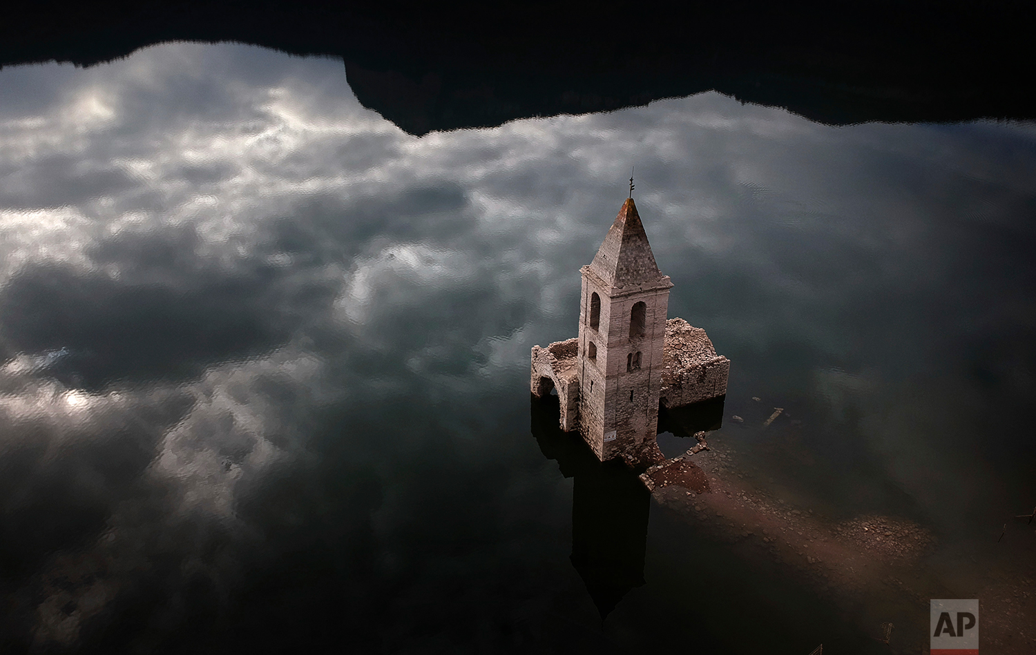 A church and remains of an ancient village which are usually covered by water are seen inside the reservoir of Sau, in Vilanova de Sau, Catalonia, Spain, Thursday, Jan 11, 2018. (AP Photo/Emilio Morenatti)