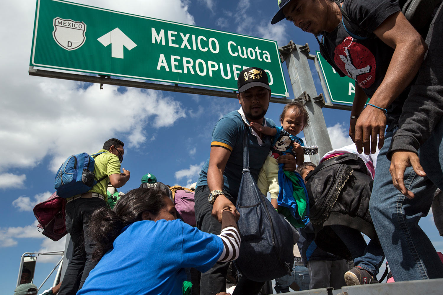  U.S.-bound Central American migrants get on to a truck for a a free ride, as part of a thousands-strong caravan moving through Puebla, Mexico, Monday, Nov. 5, 2018. (AP Photo/Rodrigo Abd) 