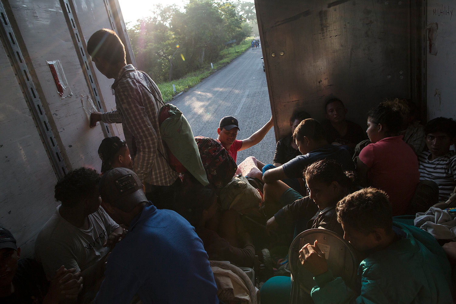  Migrants ride in the back of a truck, as a thousands-strong caravan of Central American migrants slowly makes its way toward the U.S. border, between Pijijiapan and Arriaga, Mexico, Friday, Oct. 26, 2018. (AP Photo/Rodrigo Abd) 