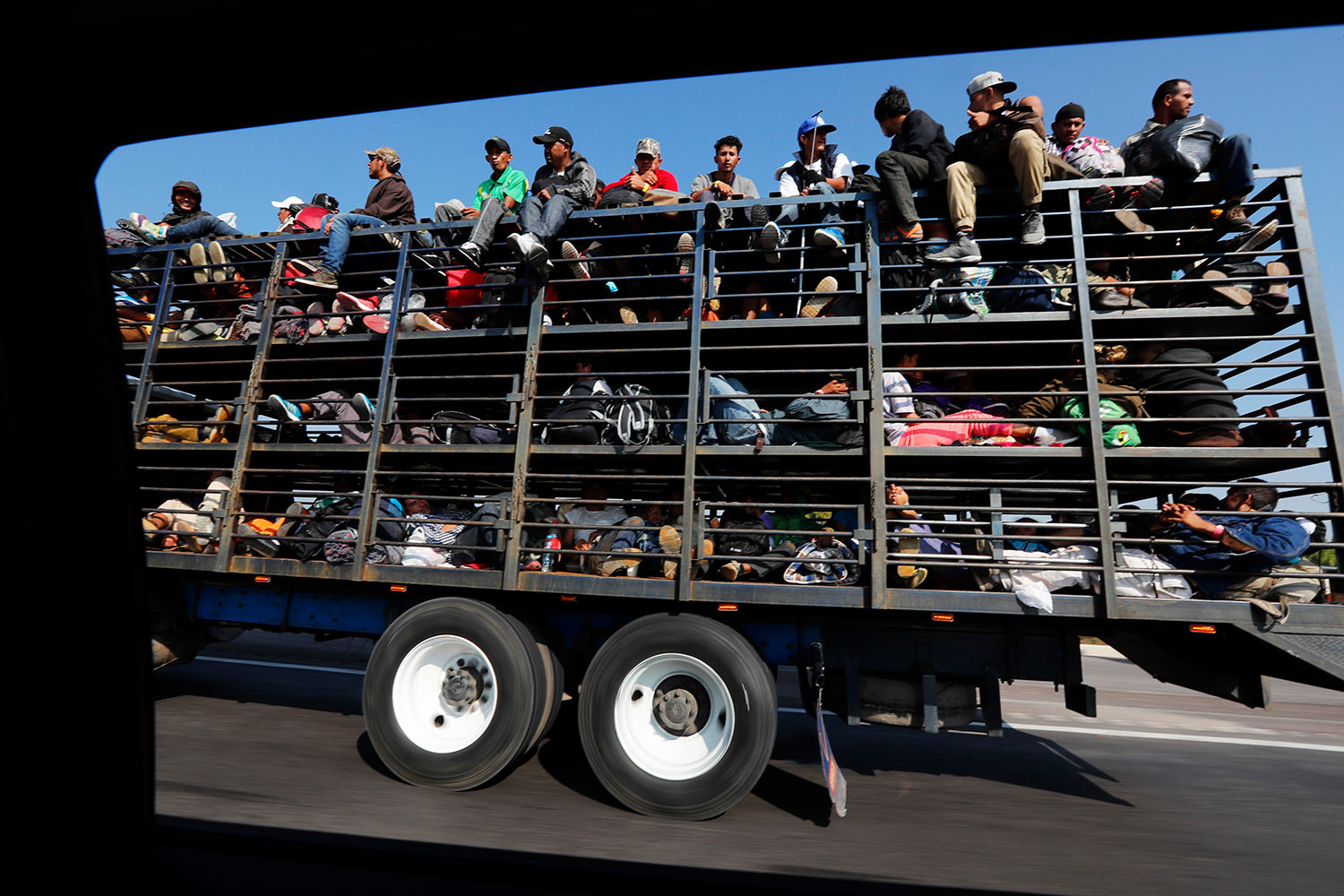  Central American migrants, part of the caravan hoping to reach the U.S. border, get a ride on a truck, in Celaya, Mexico, Sunday, Nov. 11, 2018. (AP Photo/Marco Ugarte) 