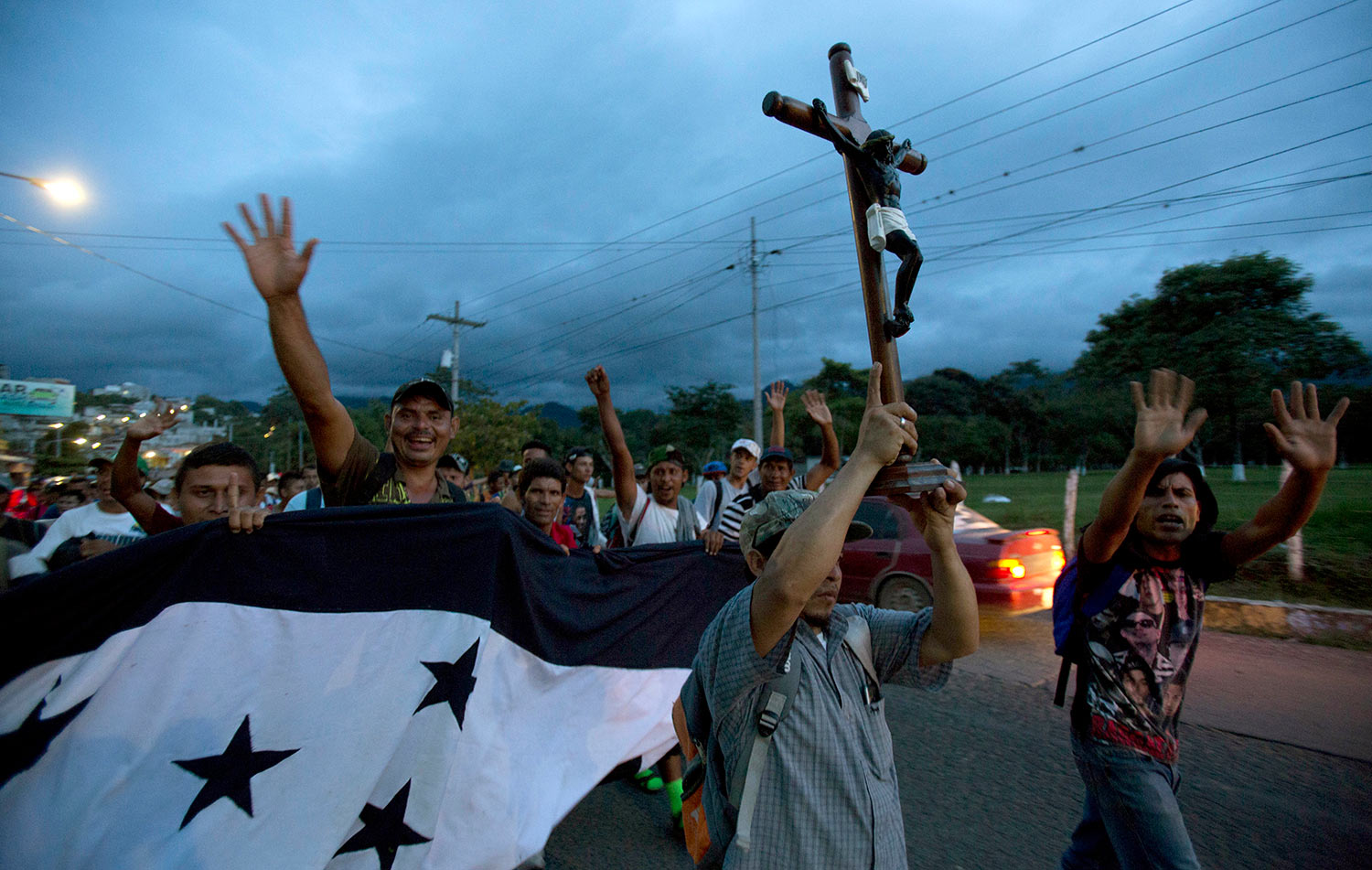  A Honduran migrant holds up a replica of the Black Christ of Esquipulas as a caravan of migrants making their way to the U.S. arrives to Esquipulas, Guatemala, Monday, Oct. 15, 2018. (AP Photo/Moises Castillo) 