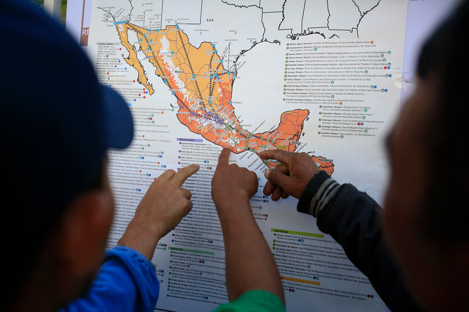  Migrants discuss their journey using a map posted inside the sports complex where thousands of migrants have been camped out for several days in Mexico City, Friday, Nov. 9, 2018. (AP Photo/Rebecca Blackwell) 