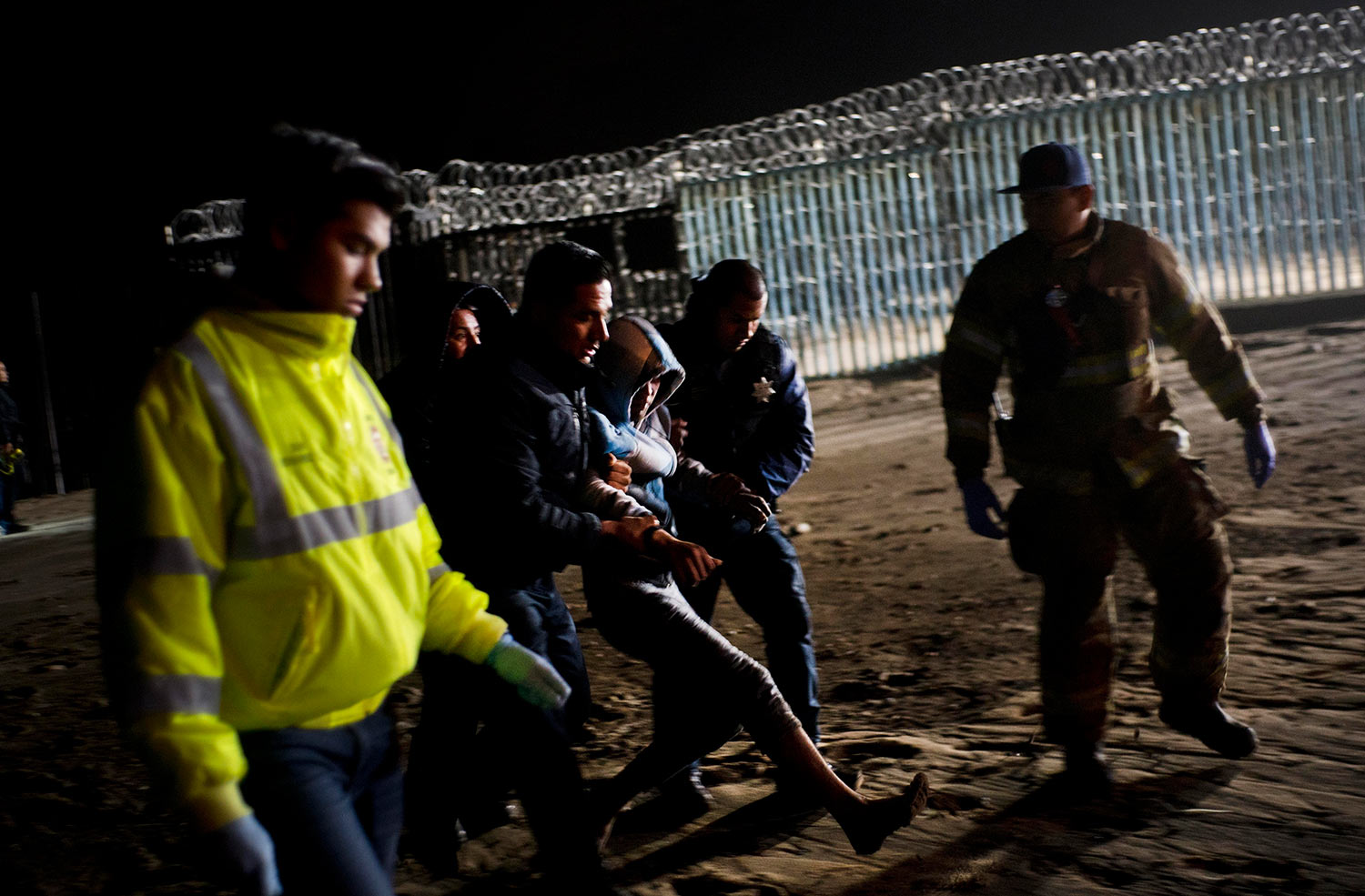  Authorities hold a Honduran migrant who was rescued after he tried to cross the US border by the sea in Tijuana beach, Mexico, Thursday, Nov. 29, 2018. (AP Photo/Ramon Espinosa) 