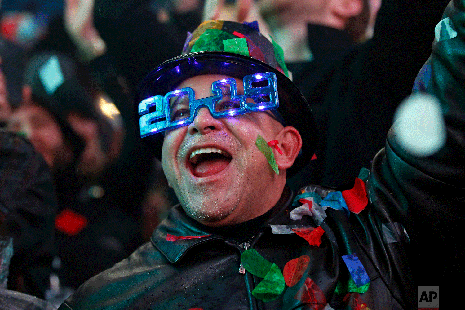 A reveler celebrates as confetti falls during a New Year's celebration in New York's Times Square, Tuesday, Jan. 1, 2019. (AP Photo/Adam Hunger)