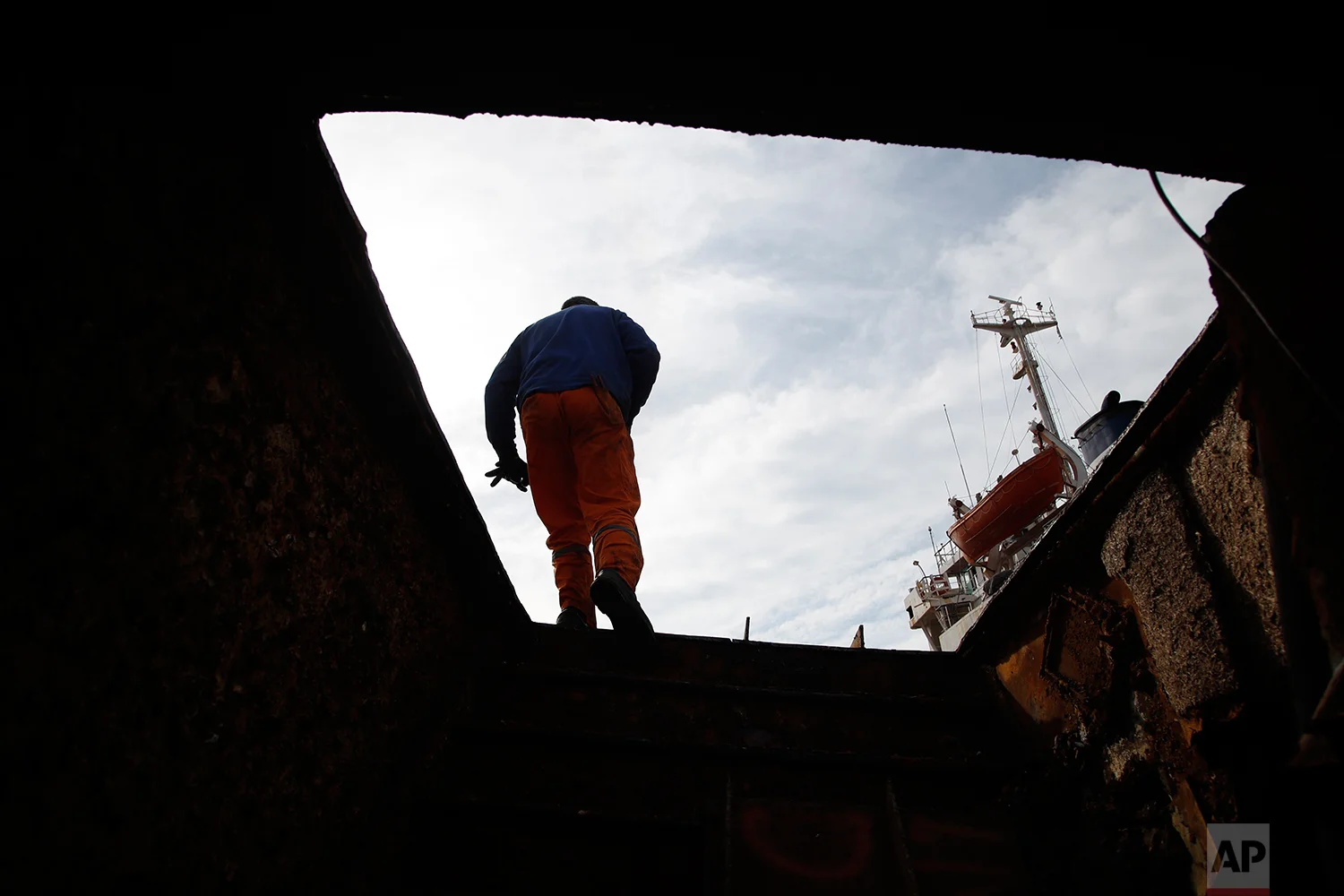 In this Monday, Nov. 5, 2018 photo, in a shipyard of Perama, west of Athens, a worker walks on a ferry that was recovered after spending years as a shipwreck. (AP Photo/Thanassis Stavrakis)