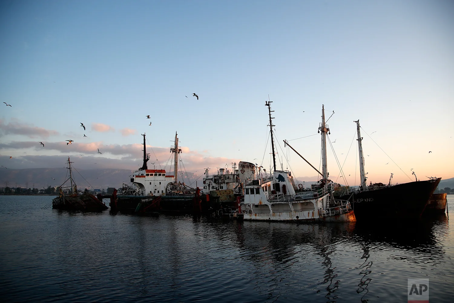 In this Friday, Dec. 4, 2018 photo, half sunken and abandoned ships, in the Gulf of Elefsina, west of Athens. (AP Photo/Thanassis Stavrakis)