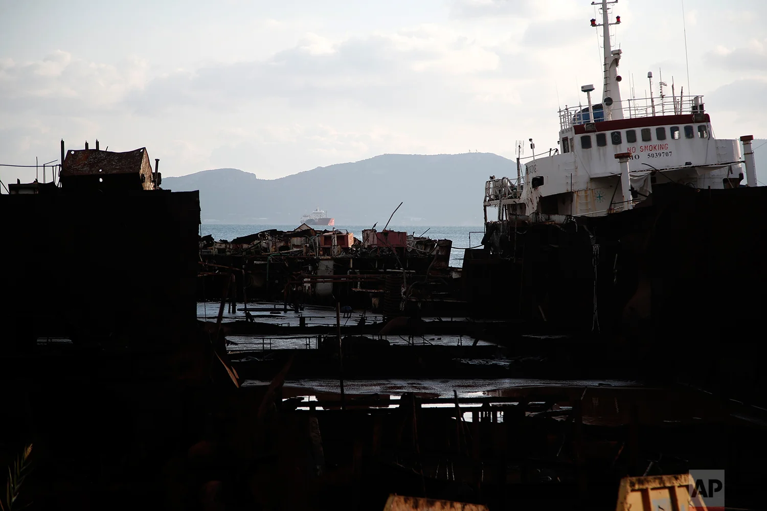 In this Wednesday, Dec. 19, 2018 photo, a cut tanker with crude oil, that was recovered after spending years as a shipwreck is photographed at a dock in Elefsina, west of Athens. (AP Photo/Thanassis Stavrakis)
