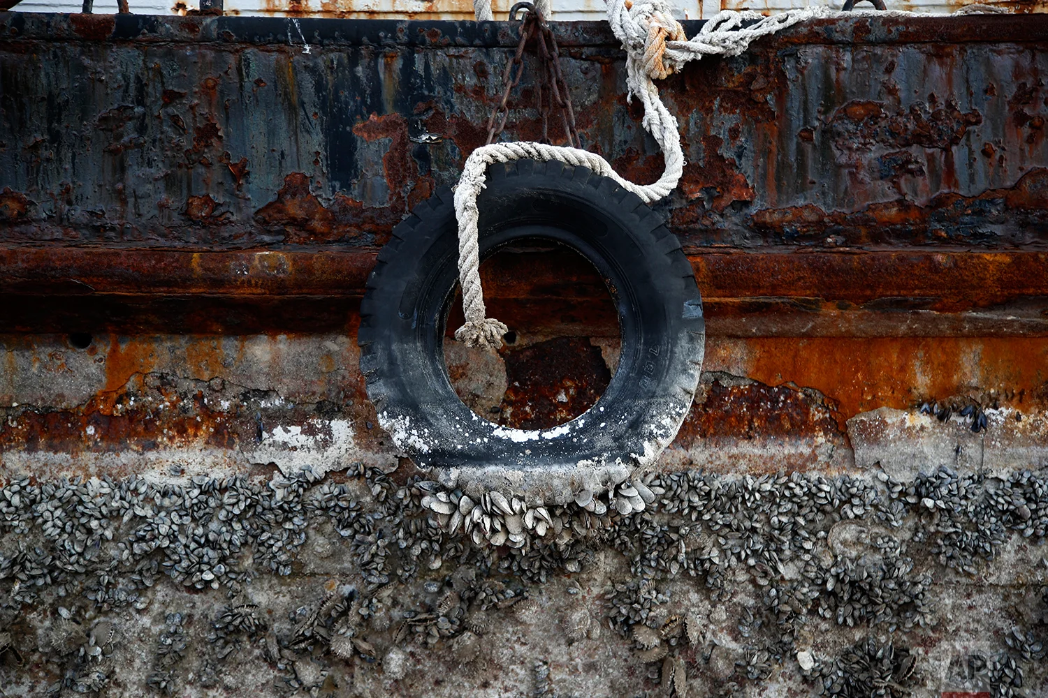 In this Tuesday, Nov. 13, 2018 photo, a small boat, that was recovered after spending years as a shipwreck is photographed at a dock in Elefsina, west of Athens. (AP Photo/Thanassis Stavrakis)