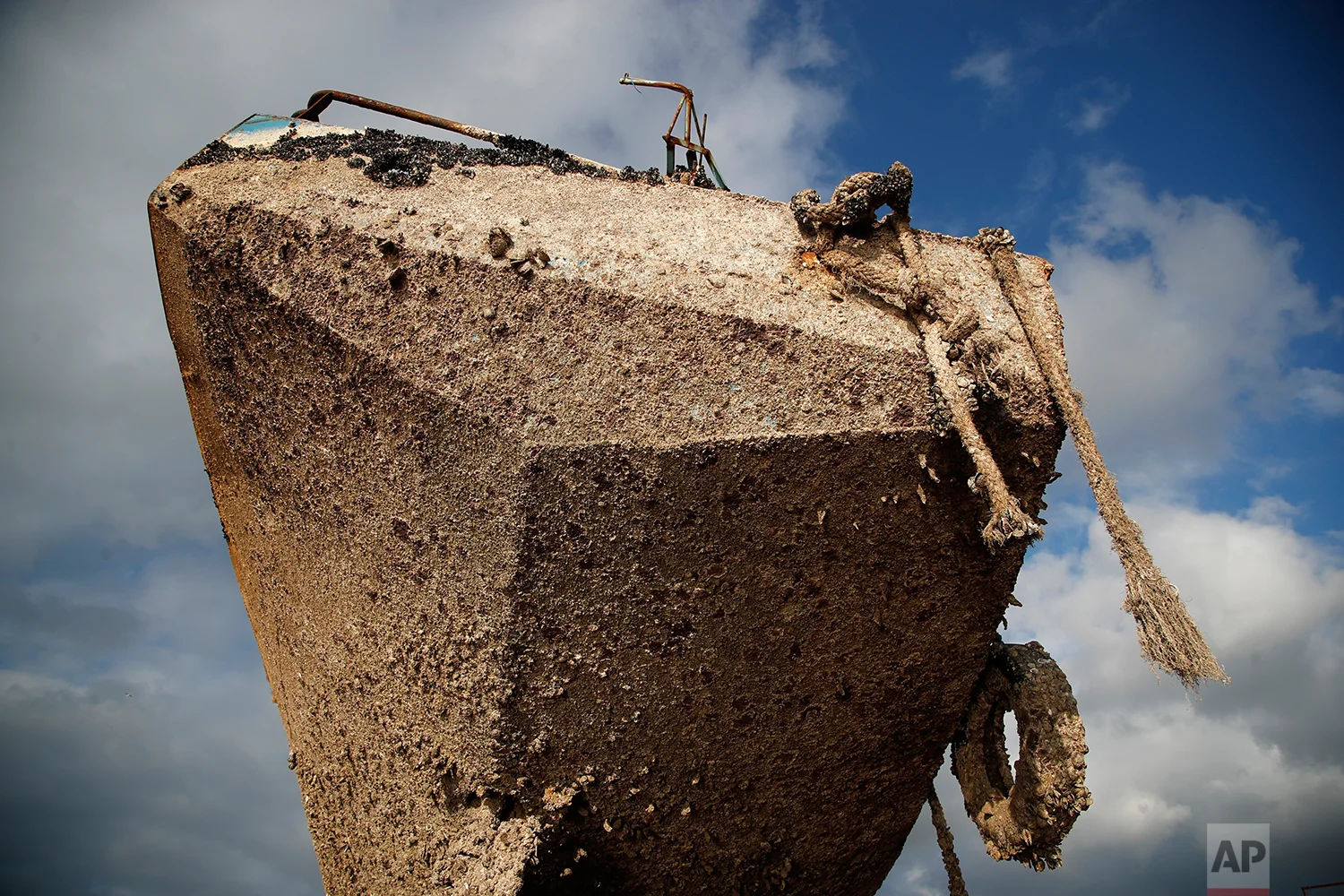 In this Wednesday, Dec. 19, 2018 photo, a small boat, that was recovered after spending years as a shipwreck is photographed at a dock in Elefsina, west of Athens. (AP Photo/Thanassis Stavrakis)