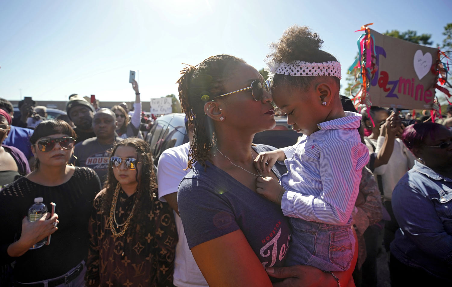 Rashaunda Jarmon holds her 3-year-old granddaughter, Parker Wallace during a community rally outside a Walmart on East Sam Houston Pkwy N in Houston on Saturday, Jan. 5, 2019 for 7-year-old Jazmine Barnes, who was killed on Sunday. Jazmine was shot to death nearby while riding in a car with her mother and three sisters. (Melissa Phillip/Houston Chronicle via AP)