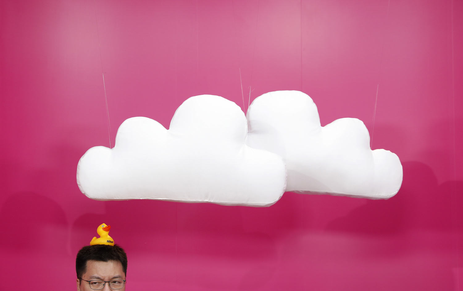 Mike Tan waits to have his picture taken in the Nikon booth at CES International electronics trade show, Tuesday, Jan. 8, 2019, in Las Vegas. (AP Photo/John Locher)