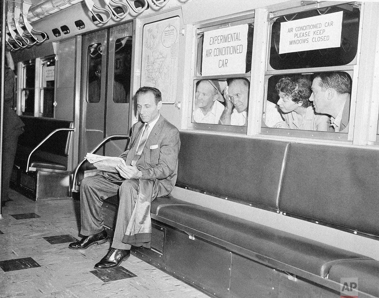  While other subway passengers perspire in the warm and humid underground station, Paul Forman appears cool and comfortable in the experimental air conditioned train which made its first run in New York City, July 9, 1956. The test run, which include