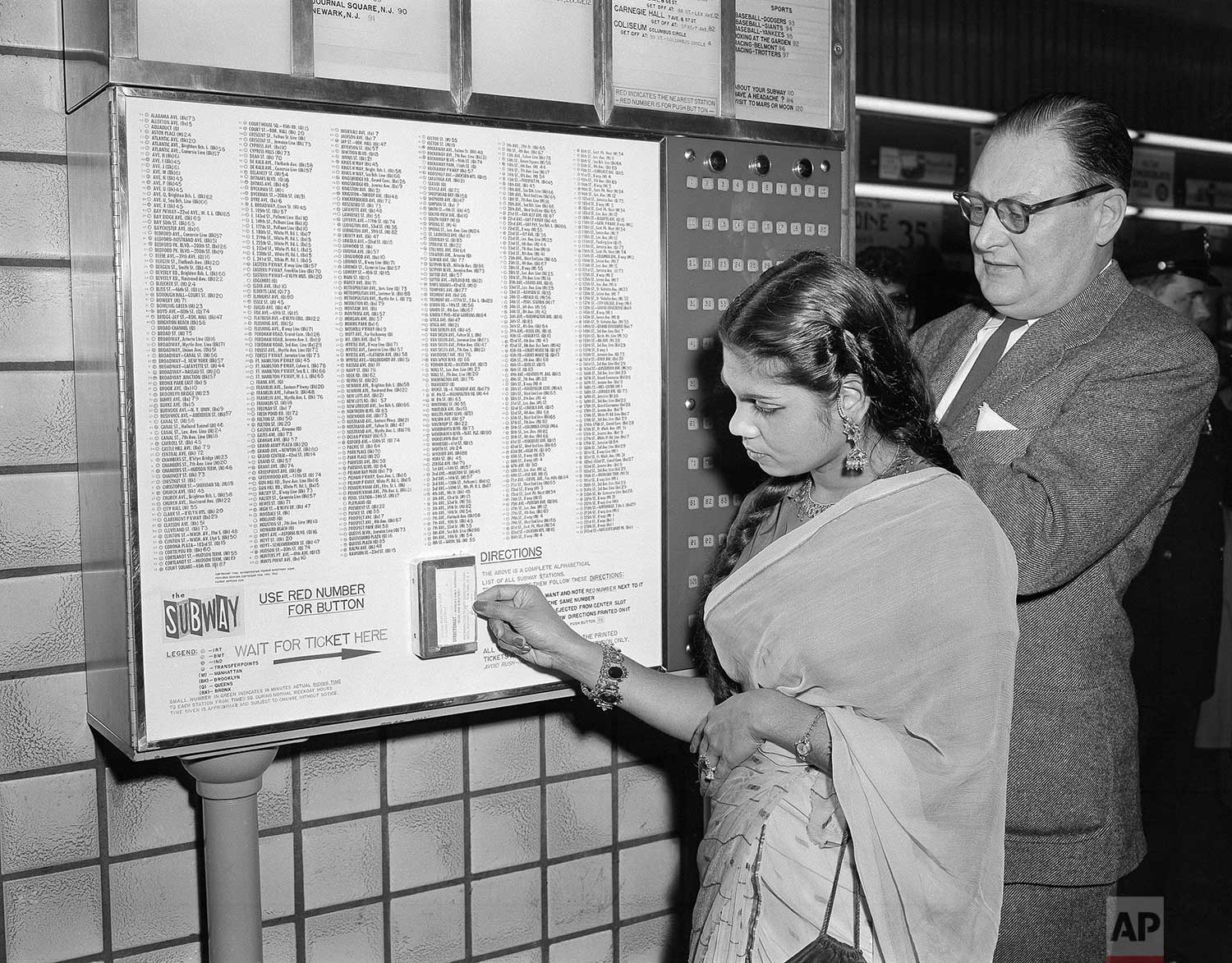  Razina Atiqullah, 23, of East Pakistan, tries out the directomat, a new device installed at the Times Square subway station in New York, April 30, 1956. (AP Photo) 