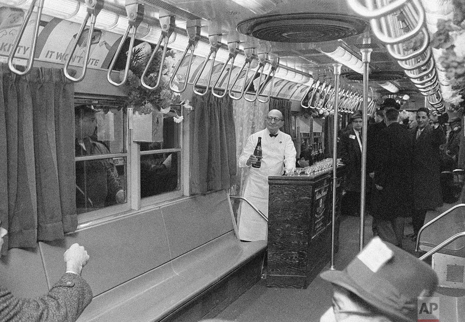  Joseph E. O'Grady, right, member of New York City's Transit Authority, stands at a bar installed temporarily in the Authority's "dream car" in New York, Jan. 17, 1962. The car, which had fresh flowers, carpeting, draperies and pastel lighting, made 